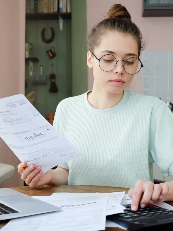 young-beautiful-woman-budgeting-managing-utilities-expenses-writing-financial-plan.jpg